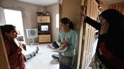 Heyam Ayyash talks to her daughters Shaymaa, left, and Asma at their rental home in Amman. The family hopes to own its first home under a government scheme for low-income earners.