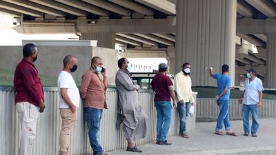 Workers wait under a bridge for odd jobs in Makkah. AFP