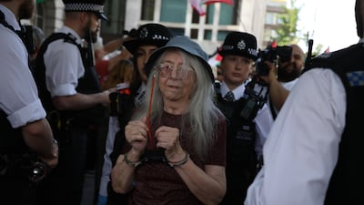 A demonstrator is detained as the activist group Defend Our Juries hold a 'Graduation Day' protest at Westminster Magistrates' Court, London. Getty Images