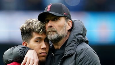 Liverpool's manager Jurgen Klopp, right, hugs Roberto Firmino. AP