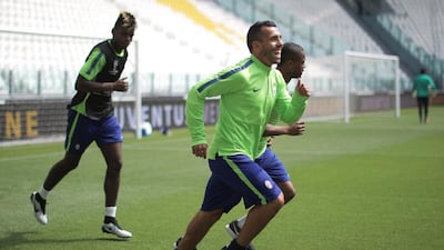Juventus players Patrice Evra and Carlos Tevez, front, and Paul Pogba jog at the team's arena in Turin on Monday in training for the Champions League final. Marco Bertorello / AFP
