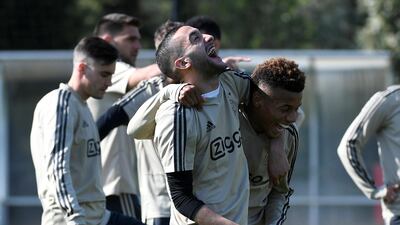 Ajax players Hakim Ziyech and David Neres share a laugh during training. Reuters