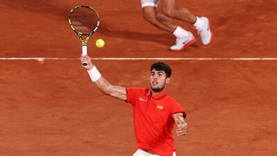 Carlos Alcaraz plays a smash as doubles partner Rafael Nadal looks on. Getty Images