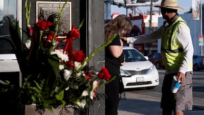 Flowers, candles and guitar picks sit next to Eddie Van Halen's hand prints on Hollywood's Rock Walk in Hollywood, California. EPA