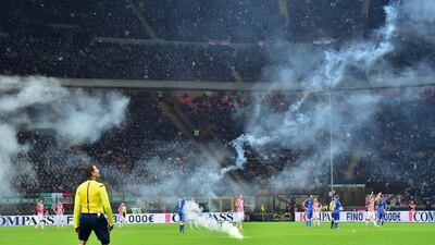 Players stop playing as Croatia supporters throw flares onto the pitch during the Euro 2016 qualifier in Milan on Sunday. Giuseppe Cacace / AFP