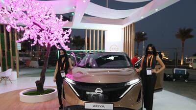 Models stand near the new Nissan Ariya. EPA