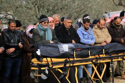 Friends and family gather to offer prayers for a loved one at Salqeen cemetery in north-west Syria. Abd Almajed Alkarh / The National