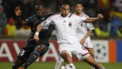 Milan's Pippo Inzaghi, right, is challenged by Marseille's Taye Taiwo on Tuesday night.