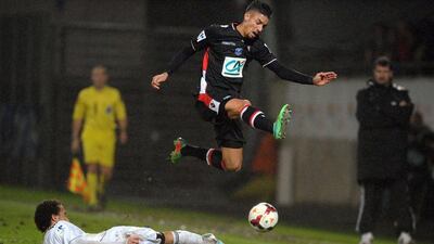 Monaco's Yannick Ferreira Carrasco leaps over a Vannes defender during Sunday's win. Ferreira Carrasco scored the winner in the 86th minute. Jean-Sebastien Evrard / AFP