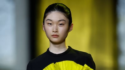 A snappy pleated mini dress worn over a long-sleeved top. EPA