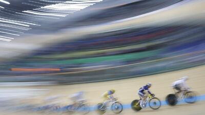 In this image made with a slow camera shutter speed, competitors race in the Women’s Omnium Tempo Race 24 at the World Track Cycling championships in Hong Kong. Kin Cheung / AP