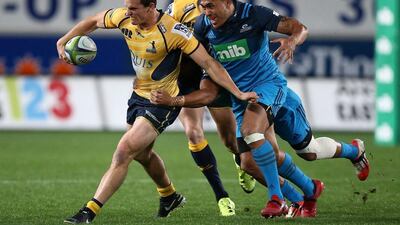 James Dargaville, left, of the ACT Brumbies is challenged by Male Sa'u of the Blues during Round 16 of Super Rugby at Eden Park in Auckland, New Zealand. David Rowland / EPA