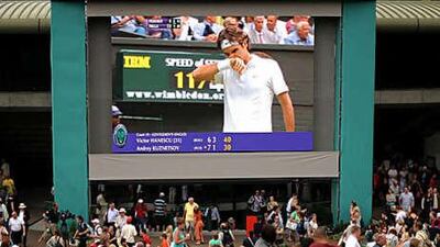 Tennis fans gather on Murray Mound to watch a big screen of the action at Wimbledon.