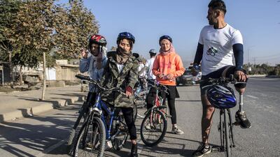Rashidi, cycling on the right, with his prosthetic leg. Stefanie Glinksi for The National
