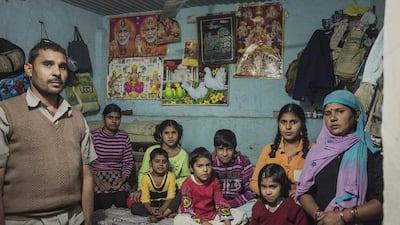 Mahesh Sharma, a gardener, originally from the neighbouring state of Uttar Pradesh, with his family of 7 children at their rented one room home in sector 17 of Gurgaon, India, where many migrant families live. Sami Siva for The National