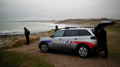 French police patrol at the coast, near Calais. Rescue workers have pulled migrants from the Channel after a boat capsized. Reuters