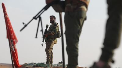 An Iraqi fighter of the Hashed Al Shaabi paramilitary force pictured on the Iraq-Syria border in 2018. 26 Iraqis from an Iran-backed paramilitary force were killed in response to an attack the Taji base that killed two Americans and a British soldier .AFP