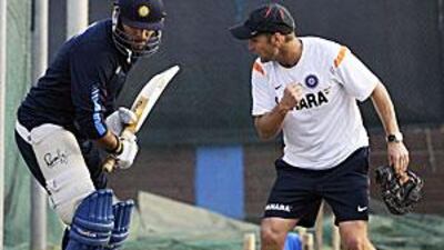 The Indian coach Gary Kirsten helps out fellow left-hander Yuvraj Singh during practice ahead of the final.