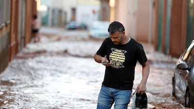 A man wades through water in Rincon del Soto. EPA