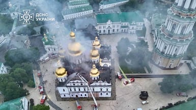 Ukrainian firefighters extinguish a blaze at a cathedral complex, which was hit during a Russian missile and drone strike on Ukraine's capital Kyiv. AFP