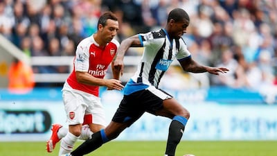 Georginio Wijnaldum of Newcastle United and Santi Cazorla of Arsenal compete for the ball during their Premier League contest on Saturday. Dean Mouhtaropoulos / Getty Images / August 29, 2015