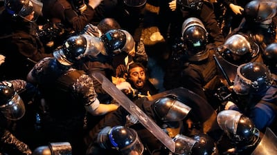 Riot police arrest an anti-government protester who was protesting outside a police headquarters in Beirut. AP Photo