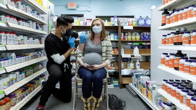 Michelle Melton, who is 35 weeks pregnant, receives the Pfizer-BioNTech vaccine against the coronavirus disease at Skippack Pharmacy in Schwenksville, Pennsylvania, US. In the UAE pregnant women and children are still excluded from Covid-19 vaccinations Reuters.