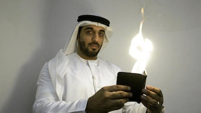 Moein Al Bastaki, an Emirati magician, performs an illusion in which he sets a wallet on flame. Jaime Puebla / The National