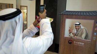 Yasser Al Gargawi is happy to get his photo taken in a Korean booth on the first night of the Korea Festival in Abu Dhabi. Delores Johnson / The National