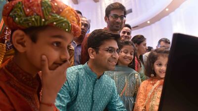 A stockbroker and his family watch a Diwali muhurat trading session on the Bombay Stock Exchange. Diwali is considered an auspicious time to invest. Getty