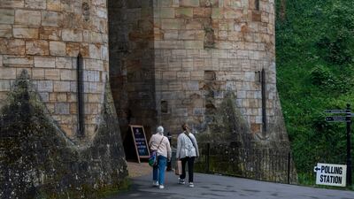 People walk towards Tonbridge Castle, being used as a polling station during local elections in Tonbridge. Reuters