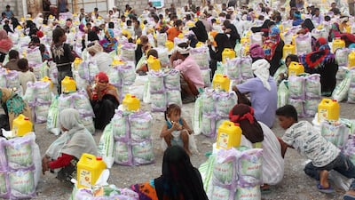 Displaced Yemenis from Durahemi receive food aid in the Red Sea port city of Hodeidah on August 9, 2019. AFP