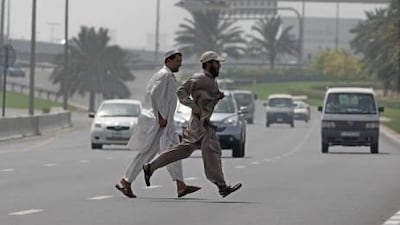 Jaywalkers cross the street on Umm Suqeim Road near the Mall of the Emirates. Pedestrian deaths account for more than a third of all road fatalities.