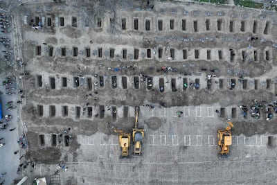 Mourners dig graves during the funeral for children killed in a strike on a girls' school. AFP