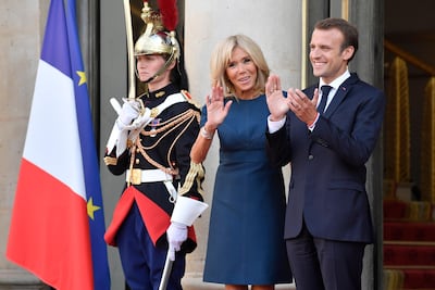 French President Emmanuel Macron and First Lady Brigitte Macron wait for the national football team players at the Elysee Palace. Julien de Rosa / EPA