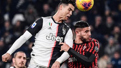 Juventus' Cristiano Ronaldo and AC Milan defender Theo Hernandez go for a header. AFP