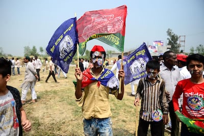 An Indian supporter of Bahujan Samaj Party (BSP), Samajwadi Party (SP) and Rashtriya Lok Dal (RLD) coalition waves party flags at the first joint rally in Uttar Pradesh state. AFP