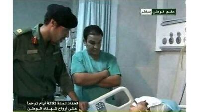 Libyan state television yesterday broadcast images of a man it said is Khamis Qaddafi, left, visiting victims of a Nato air strike in Tripoli.