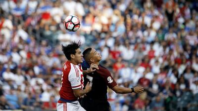 Paraguay’s Gustavo Gomez, left, and United States’ Bobby Wood go up for the ball during the first half. Matt Rourke / AP Photo