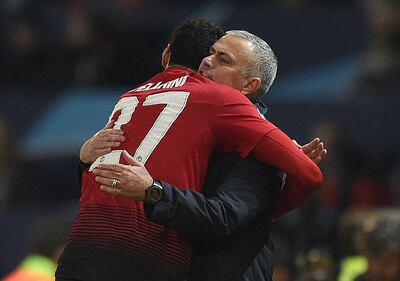 Manchester United match-winner Marouane Fellaini hugs manager Jose Mourinho. AFP