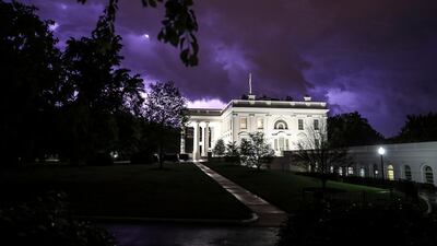 Lightning illuminates the clouds of a thunderstorm behind the White House in Washington, DC, USA. EPA
