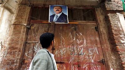A Yemeni looks at a poster of Yemeni ex-president Ali Abdullah Saleh in the old city of Sana'a, Yemen. Yahya Arhab / EPA