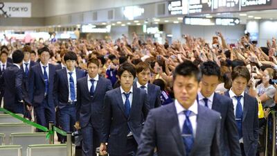 Japan national team players arrive back home at Narita Airport on Friday after the squad had a disappointing campaign in Brazil. Kazuhiro Nogi / AFP
