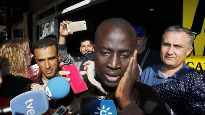 A young unemployed immigrant reacts after discovering that he has one ticket of the number 79,140, the first prize of El Gordo Christmas lottery, in Roquetas de Mar, Andalusia, southern Spain, on December 22. EPA