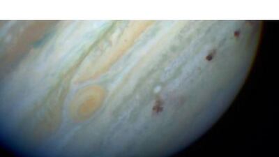 The effect of the comet Shoemaker-Levy 9, which came close to Jupiter in 1994 and was torn apart, dumped a large amount of water into the planet's atmosphere and left a series of brown scars on the planet's southern hemisphere.