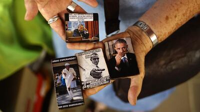 An artisan sells refrigerator magnets with images of Barack Obama in Havana. Ramon Espinosa / AP Photo