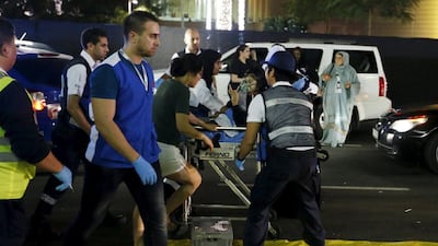 Medics evacuate a wounded person outside the Address Downtown Dubai hotel and residential block after a fire engulfed the skyscraper in downtown Dubai. Ahmed Jadallah / Reuters