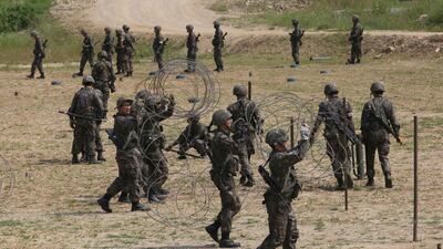 South Korean army soldiers prepare barbed wires during a military exercise in Paju, South Korea, near the border with North Korea, Monday, Sept. 4, 2017. Following U.S. warnings to North Korea of a "massive military response," South Korea's military on Monday fired missiles into the sea to simulate an attack on the North's main nuclear test site a day after Pyongyang detonated its largest ever nuclear test explosion. (AP Photo/Ahn Young-joon)