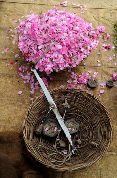 Indian flower farmers weigh petals at a farm in Kannauj in the northern state of Kanpur. In the remote town of Kannauj, the perfume capital of India, traditional workers are struggling to keep their craft alive in the face of fierce competition from modern fragrance makers. AFP PHOTO/ SAJJAD HUSSAIN / AFP PHOTO / SAJJAD HUSSAIN