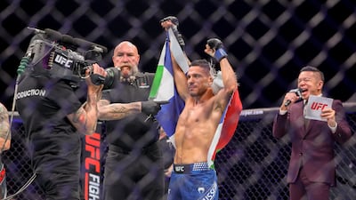Abdul Hussein celebrates with the flags of Finland and Palestine after his victory over Cody Gibson at UFC Abu Dhabi. Victor Besa / The National